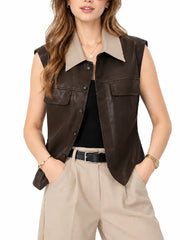 Front view of woman wearing a brown sheepskin leather button-front vest with beige collar and chest flap pockets over a black top