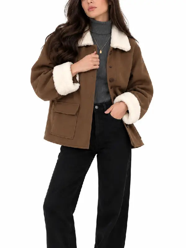Front view of women's brown button-front short coat with sherpa collar and flap pockets, worn with a gray turtleneck