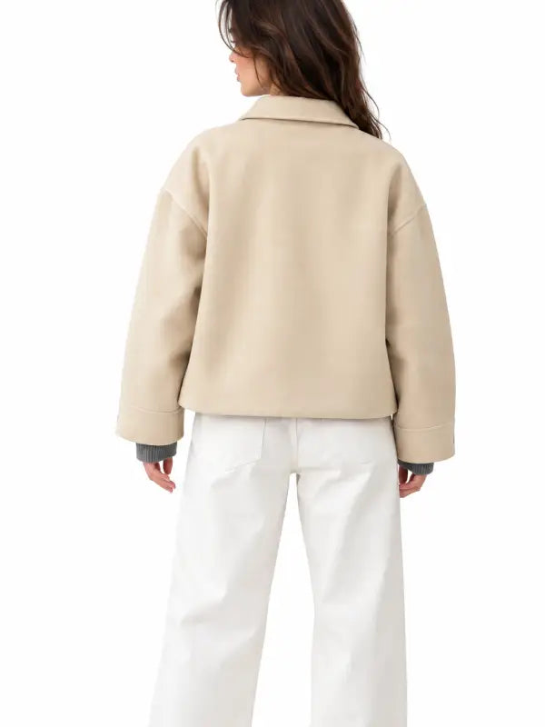 Back view of women's beige wool blend cropped jacket with dropped shoulders and wide tab cuffs