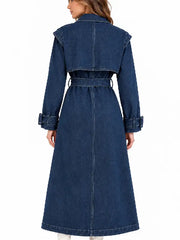 Back view of women's oversized blue denim trench coat with belted waist and dropped shoulders