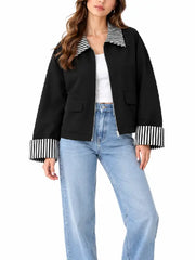 Front view of women’s black cropped zip-up jacket with striped collar, flap pockets, and striped folded cuffs
