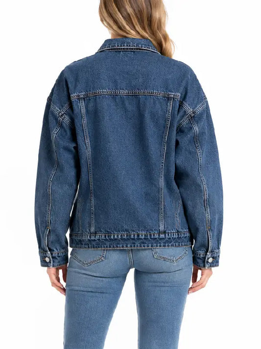Back view of oversized medium wash denim trucker jacket showing seam detailing