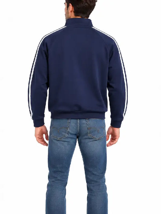 Back view of man wearing navy striped track jacket with jeans