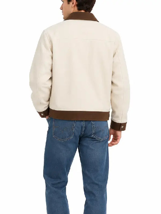 Back view of a man wearing a cream jacket with a brown contrast collar, cuffs, and hem, styled with blue jeans