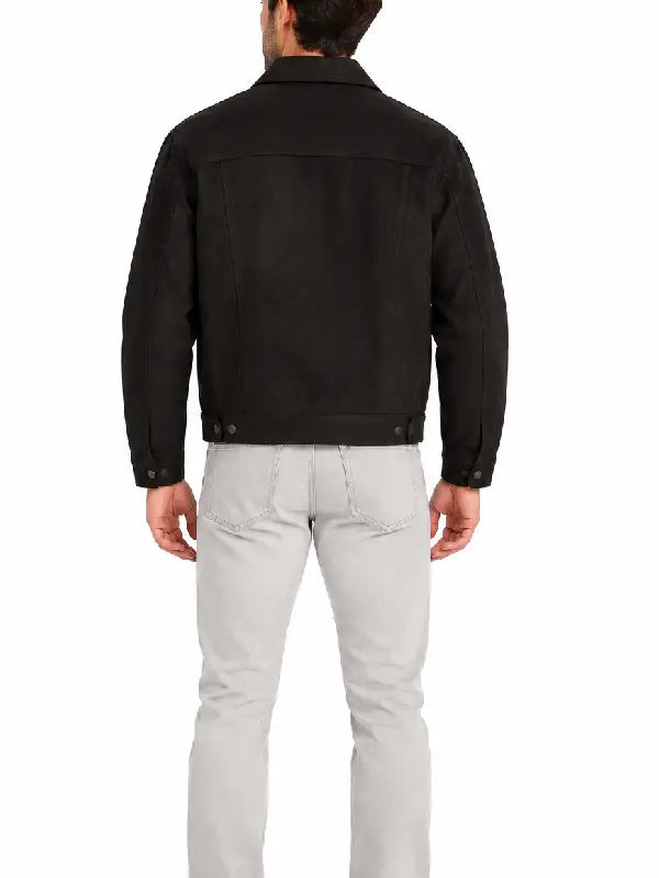 Back view of man wearing black suede trucker jacket with gray jeans