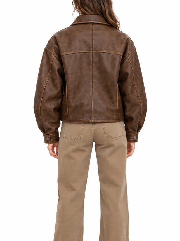 Back view of women’s oversized vintage brown leather jacket with snap button cuffs