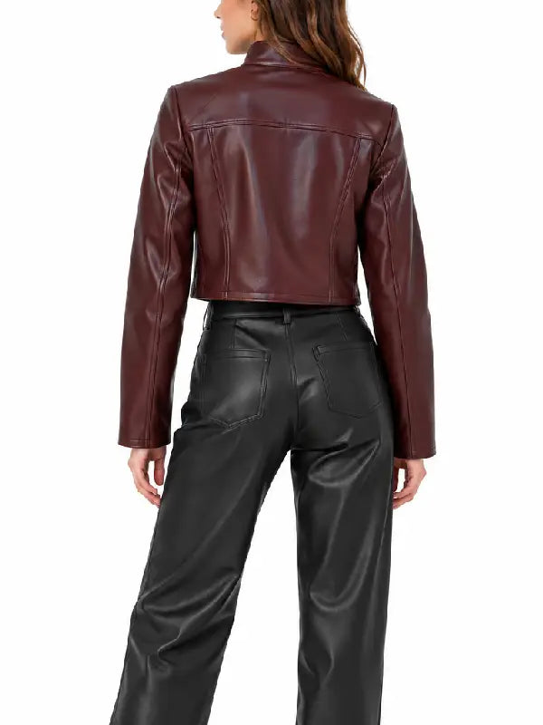 Back view of women’s burgundy cropped leather jacket with stand collar and slim long sleeves worn with black leather pants