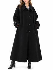 Front view of a women's black long button-up coat with a wide spread collar, side pockets, and flared silhouette