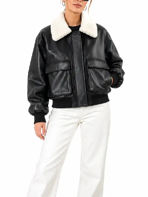 Women's black cropped leather bomber jacket with flap pockets styled with white jeans