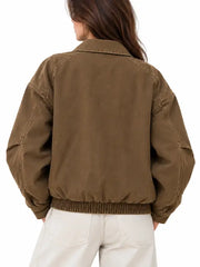 Back view of women's brown vintage canvas bomber jacket with elastic hem and dropped shoulders