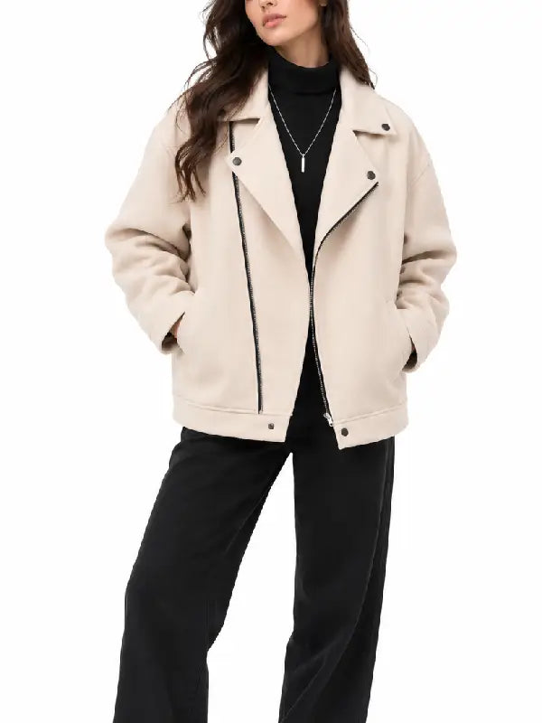 Front view of women's beige asymmetrical zip biker jacket with lapel collar, worn with a black turtleneck