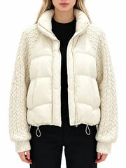 Front view of women's cream cropped puffer jacket with funnel collar, zipper and knit sleeves