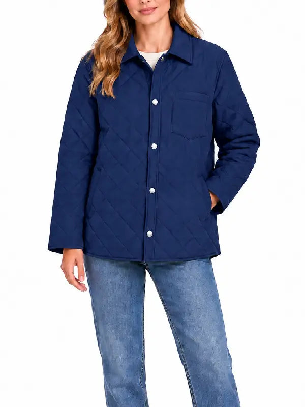 Woman wearing navy diamond quilted shirt jacket, front view with snap closure