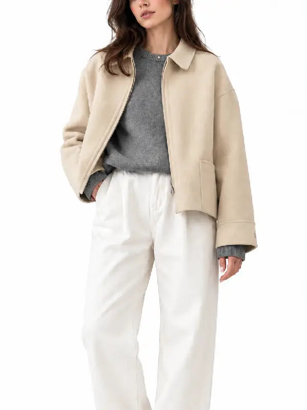 Front view of women's beige zip-up woolen jacket with shirt collar and patch pocket styled over a grey sweater